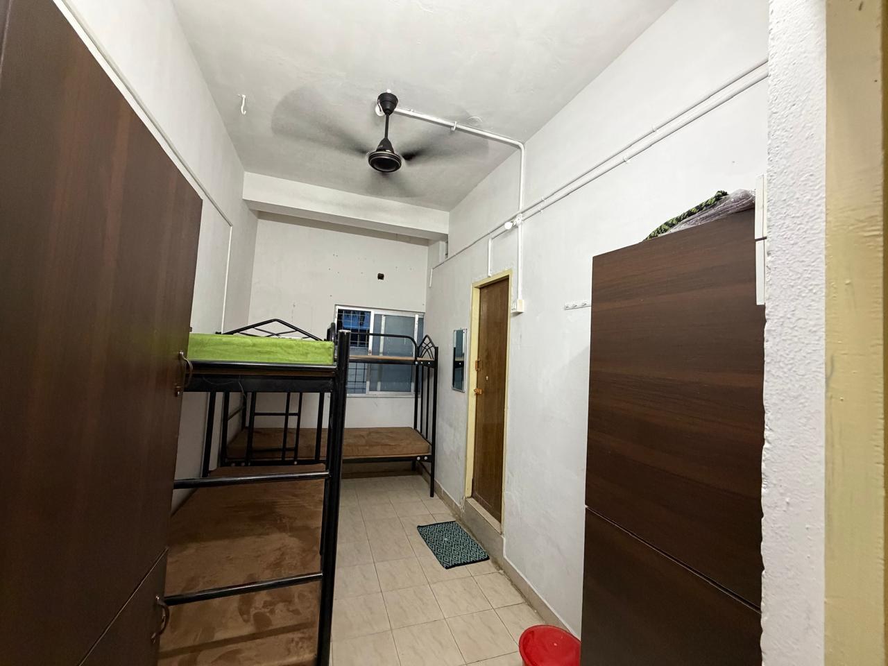 Four sharing room entrance with personal wardrobes and ceiling fan