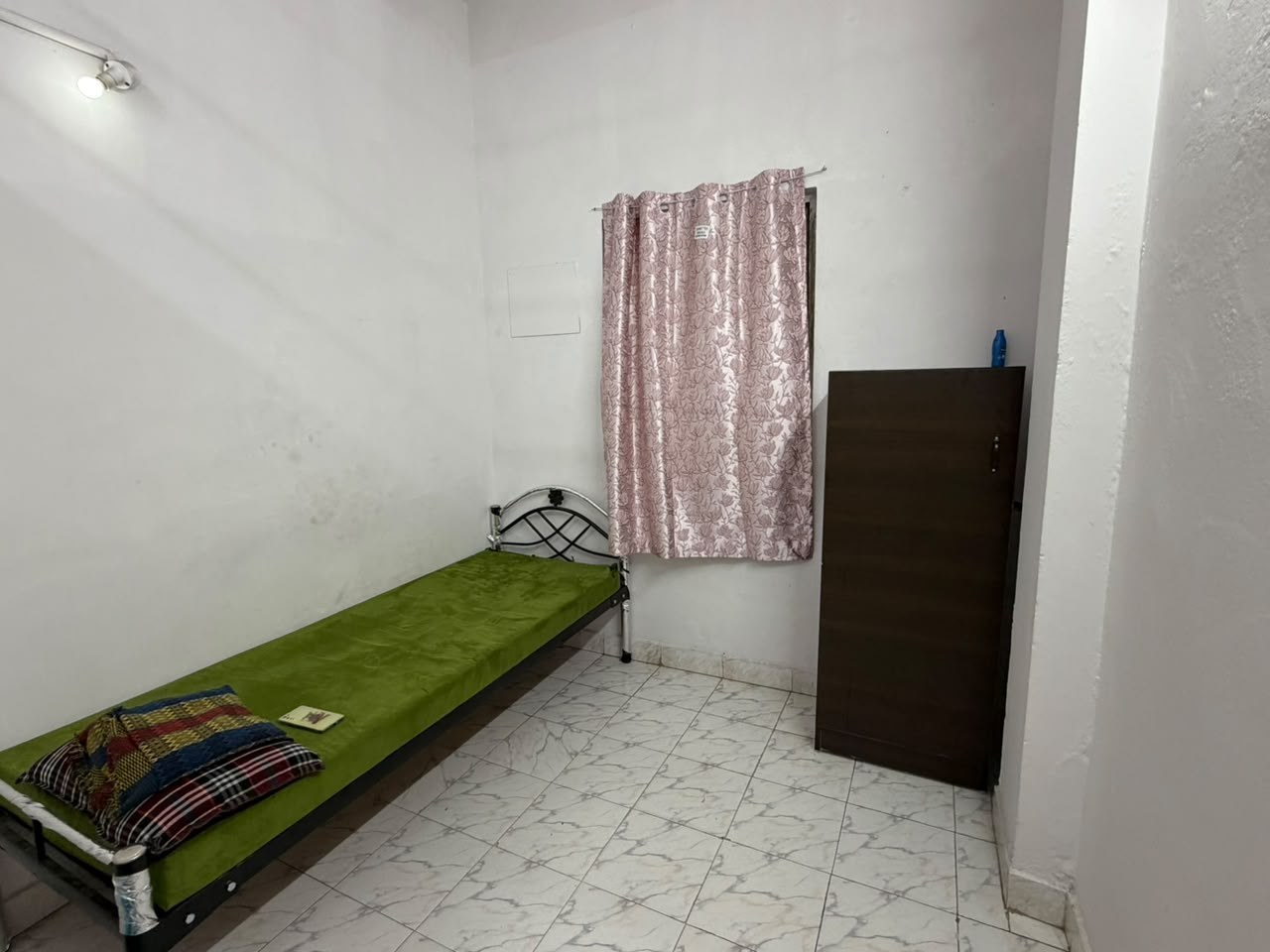 Private single room with fresh mattress, curtained window and tall wooden wardrobe